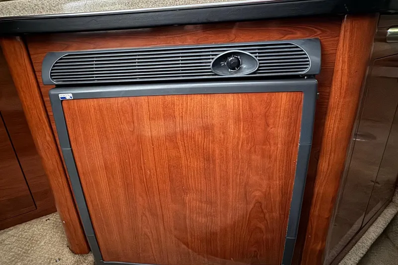 Slide: The Image of Wood-paneled refrigerator in 2007 Sea Ray 260 Sundancer boat interior. - 20
