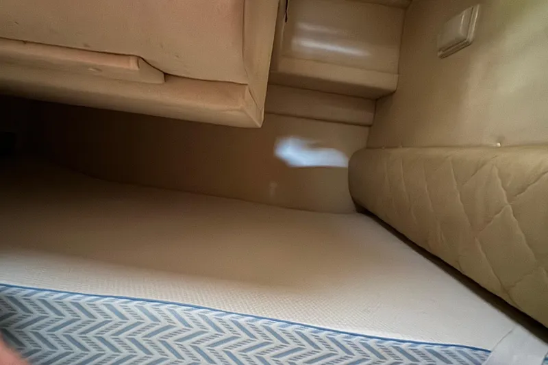 Slide: The Image of Interior cabin of 2007 Sea Ray 260 Sundancer with beige upholstery and mattress. - 21