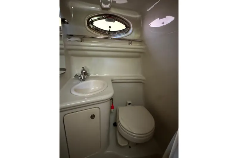 Slide: The Image of Compact bathroom in 2007 Sea Ray 260 Sundancer boat with sink and toilet. - 23