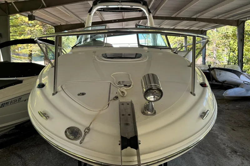 Slide: The Image of 2007 Sea Ray 260 Sundancer boat under a covered dock, front view. - 4
