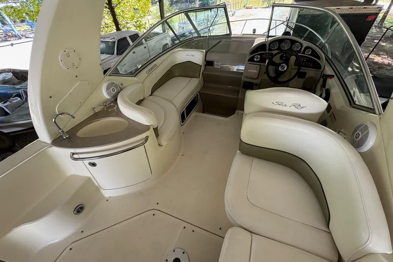 Slide: The Image of 2007 Sea Ray 260 Sundancer boat interior with helm, seating, and sink. - 9