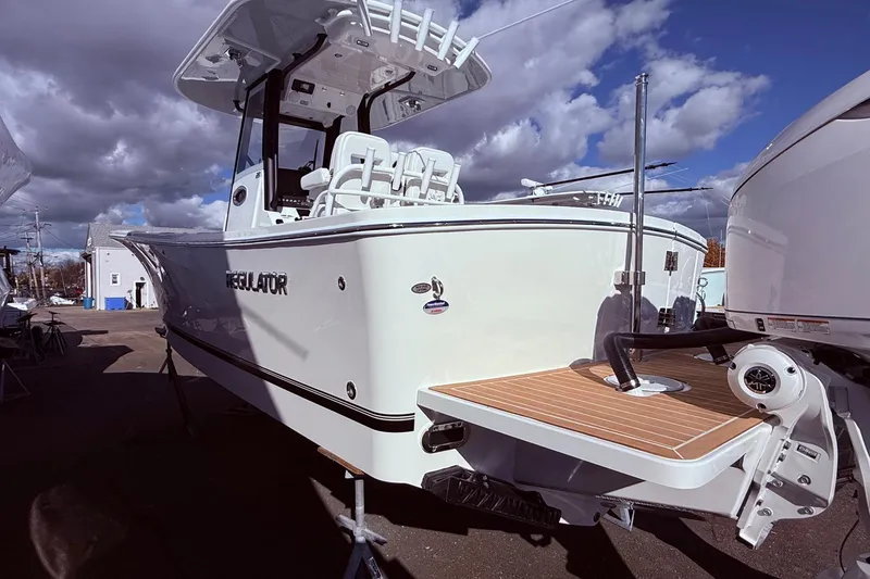 Slide: The Image of 2026 Regulator 28 boat with sleek design, docked under cloudy sky. - 10