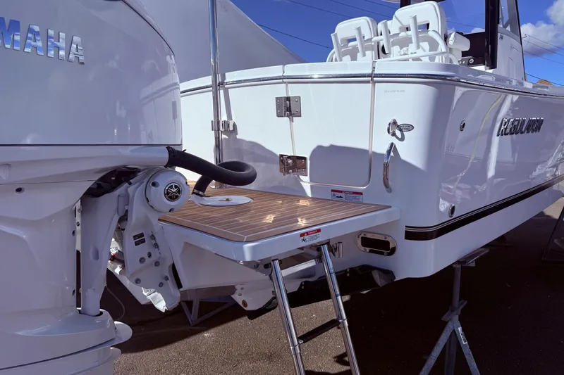 Slide: The Image of 2026 Regulator 28 boat with Yamaha engine, featuring a swim platform and ladder. - 12