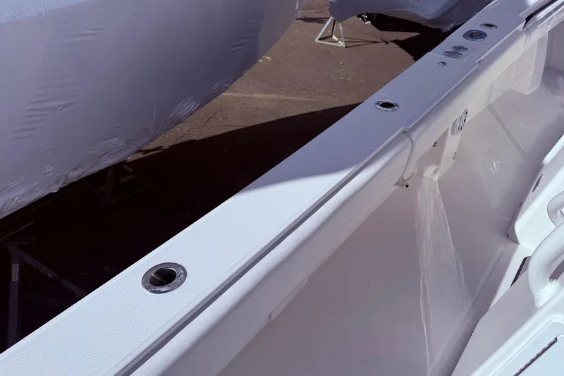 Slide: The Image of 2026 Regulator 28 boat interior detail with rod holders and sleek design. - 17