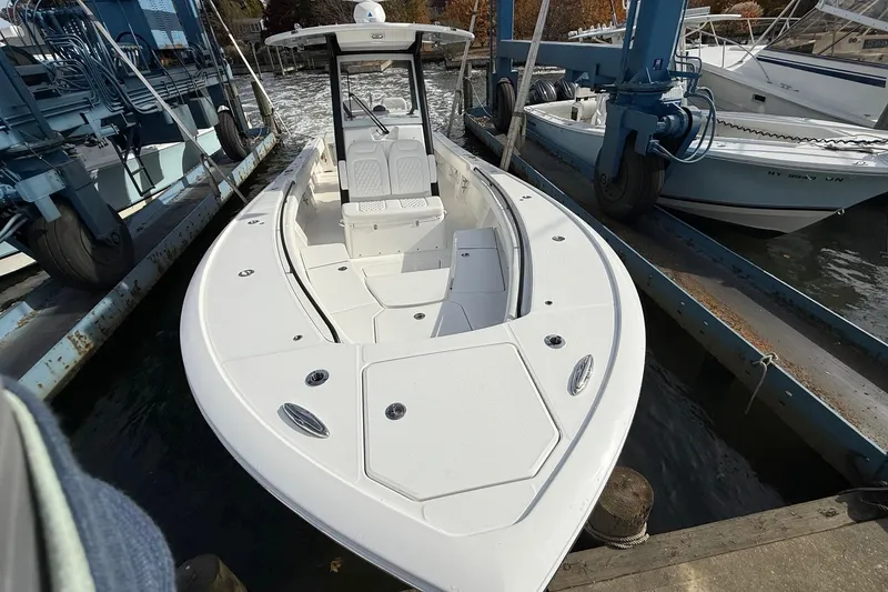 Slide: The Image of 2026 Regulator 28 boat docked, showcasing sleek design and spacious deck. - 2