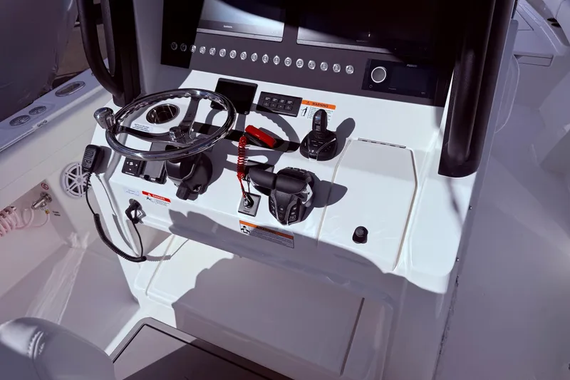 Slide: The Image of Helm of 2026 Regulator 28 boat with steering wheel and controls. - 21