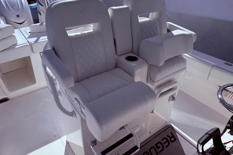 Slide: The Image of Luxurious seating on 2026 Regulator 28 boat, featuring plush, quilted upholstery. - 23