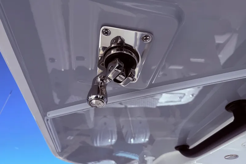 Slide: The Image of Chrome lever on 2026 Regulator 28 boat ceiling, against clear blue sky. - 24