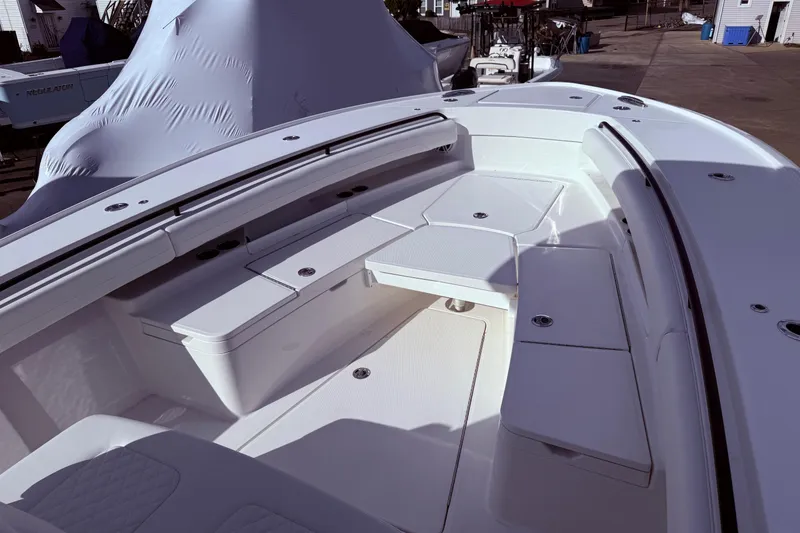 Slide: The Image of 2026 Regulator 28 boat interior with white seating and storage compartments. - 25