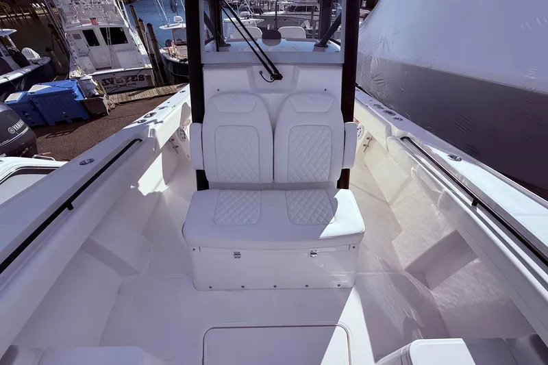 Slide: The Image of 2026 Regulator 28 boat interior with white seating and console, docked at marina. - 27