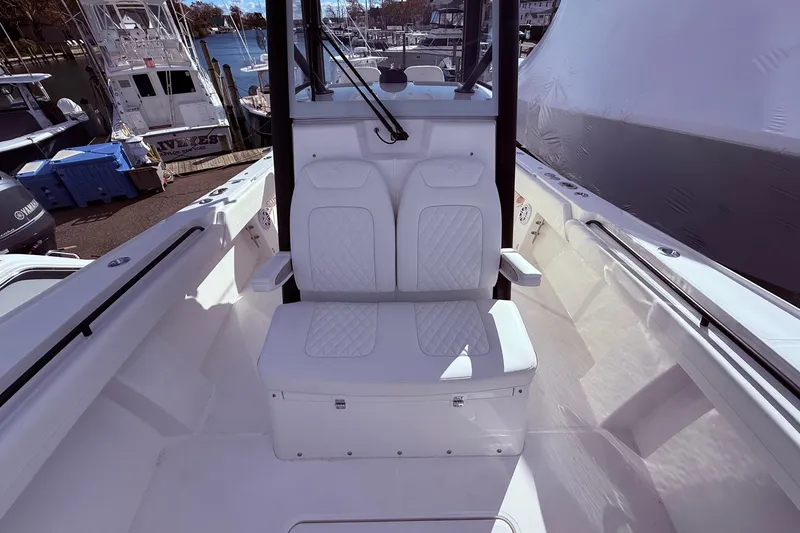 Slide: The Image of 2026 Regulator 28 boat interior with white seating and marina background. - 29