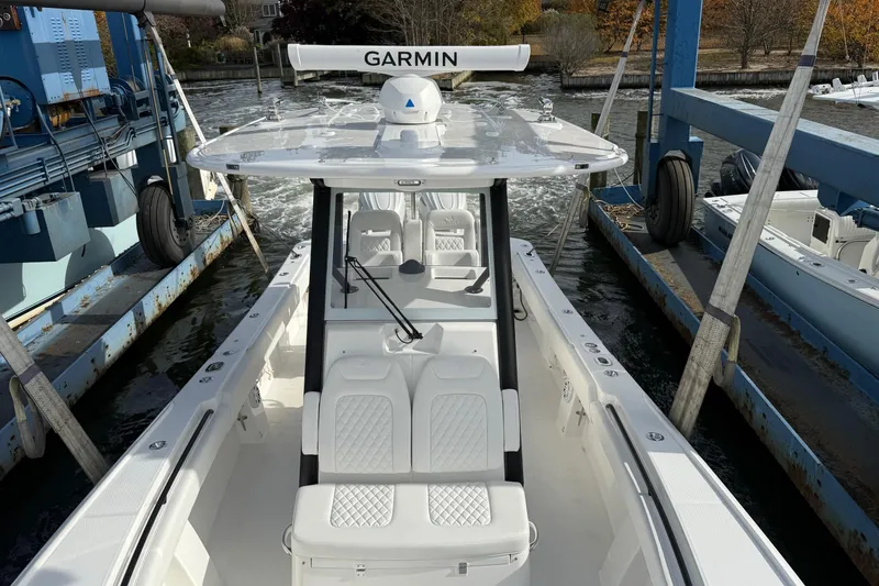 Slide: The Image of 2026 Regulator 28 boat with Garmin equipment, docked in a marina. - 3