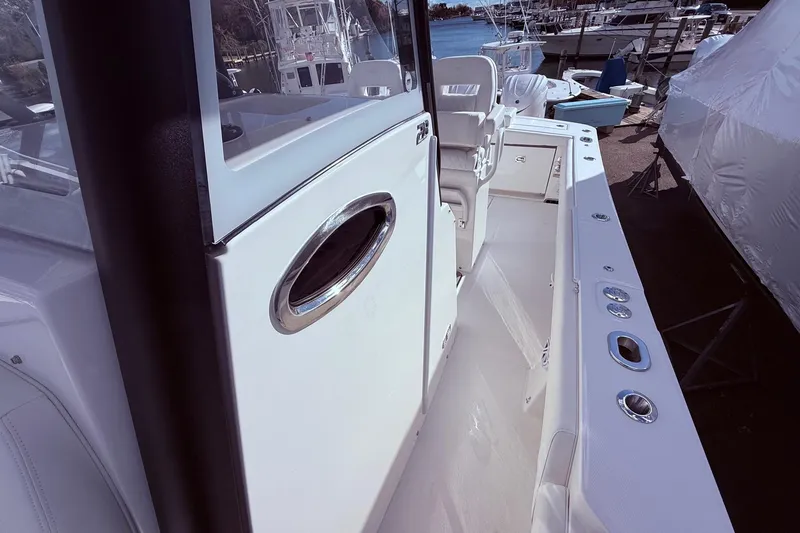 Slide: The Image of 2026 Regulator 28 boat interior with sleek design and modern features at a marina. - 30