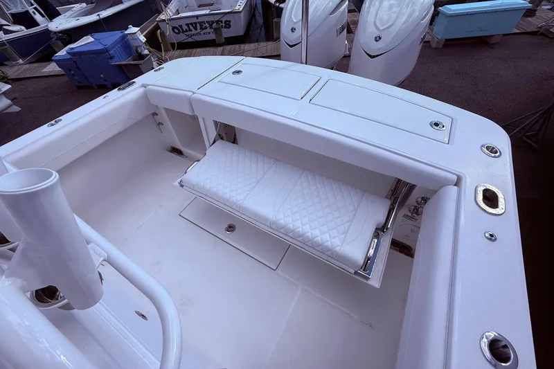 Slide: The Image of 2026 Regulator 28 boat interior with white seating and storage compartments. - 34