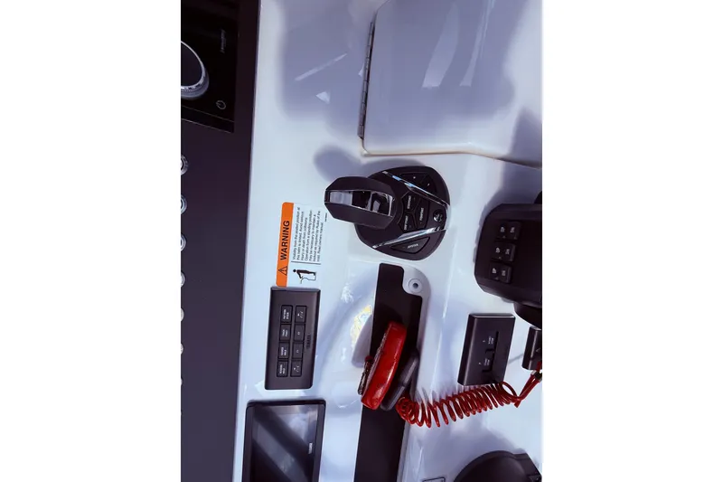 Slide: The Image of Control panel of a 2026 Regulator 28 boat with warning label and switches. - 36