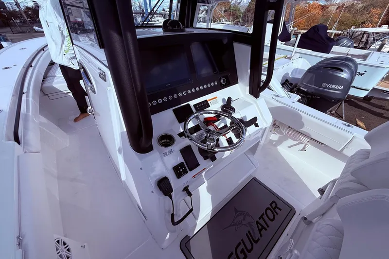 Slide: The Image of 2026 Regulator 28 boat cockpit with steering wheel and Yamaha engine in view. - 40
