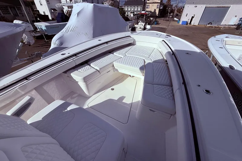 Slide: The Image of 2026 Regulator 28 boat with spacious, cushioned seating in a marina setting. - 42
