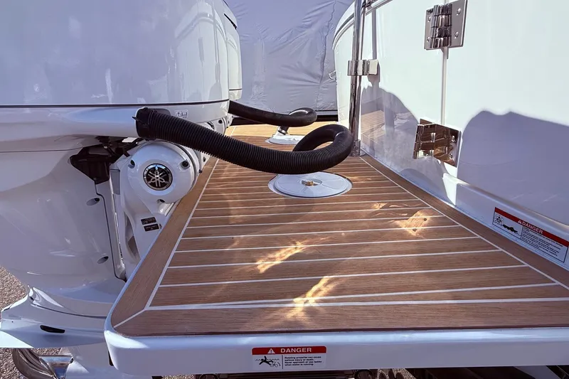 Slide: The Image of 2026 Regulator 28 boat with teak deck and Yamaha outboard motor. - 8