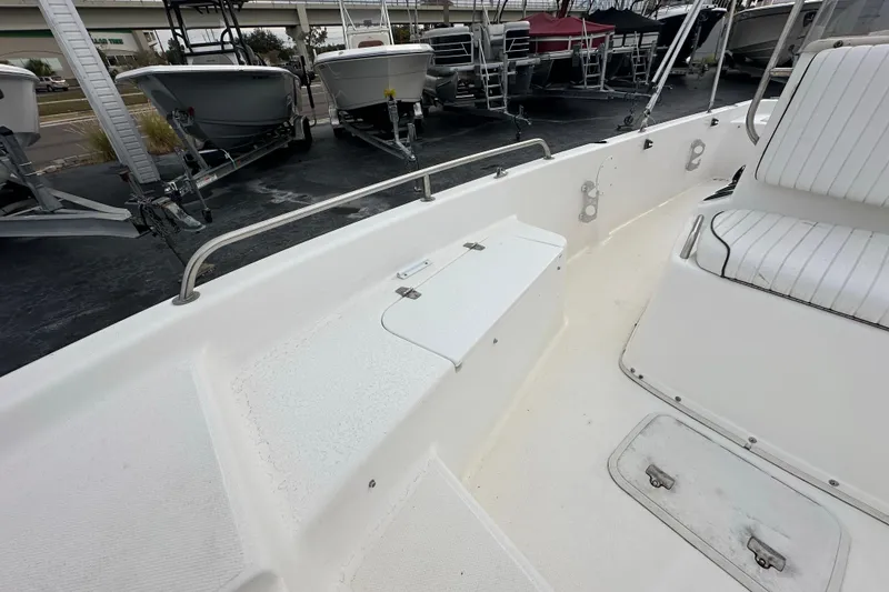 Slide: The Image of 2001 Century 2101 Bay Boat interior with white seating and storage compartments. - 11