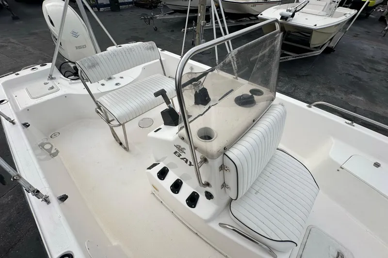 Slide: The Image of 2001 Century 2101 Bay Boat interior with seating and console, featuring a Suzuki 150 engine. - 14