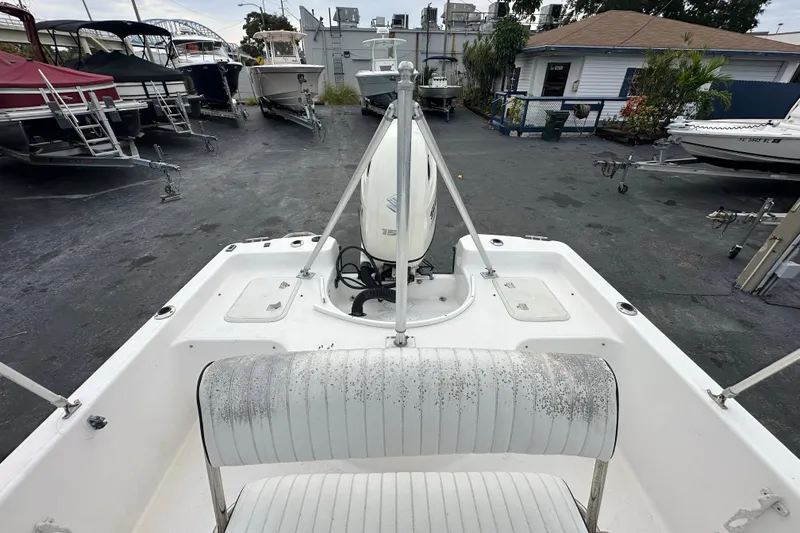 Slide: The Image of 2001 Century 2101 Bay Boat in a marina, showing seating and motor. - 22