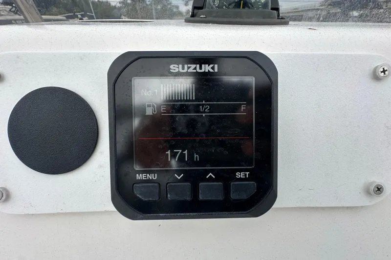 Slide: The Image of Suzuki boat display showing fuel gauge and 171 hours on a Century 2101 Bay Boat. - 24