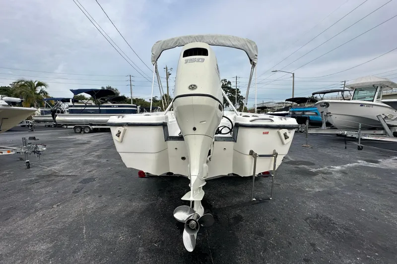 Slide: The Image of 2001 Century 2101 Bay Boat with outboard motor in a marina setting. - 4