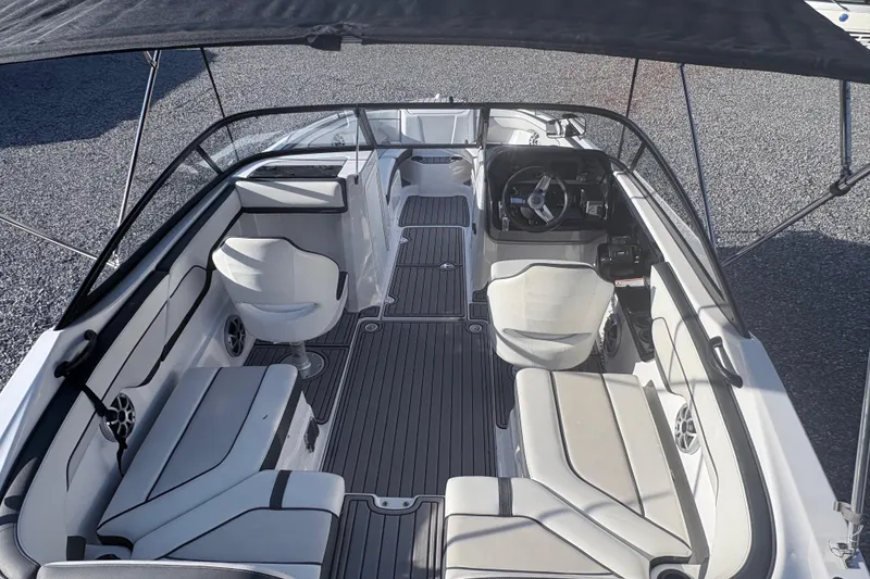 Slide: The Image of 2019 Yamaha Boats SX210 interior with seating and steering wheel under canopy. - 5