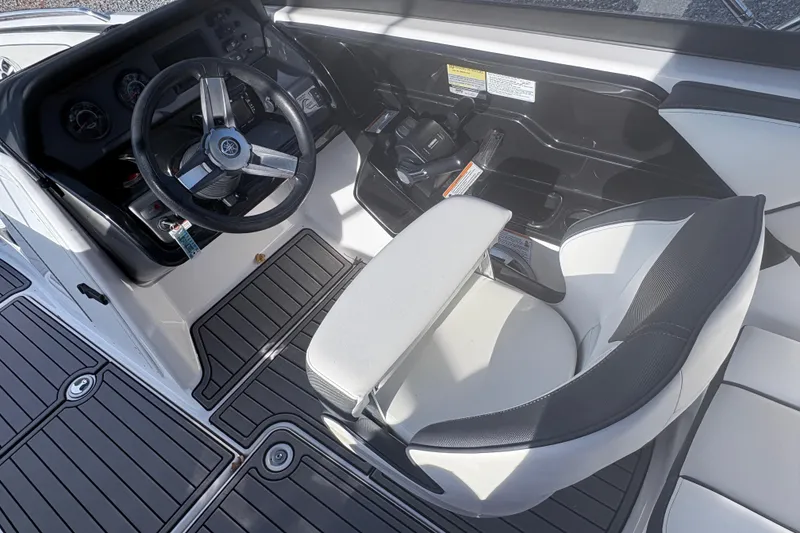 Slide: The Image of 2019 Yamaha Boats SX210 cockpit with steering wheel and seating. - 7