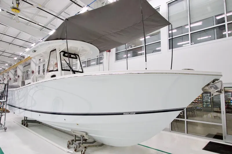 The Image of 2026 Regulator 31 boat in a modern indoor facility, showcasing sleek design and craftsmanship. - 10