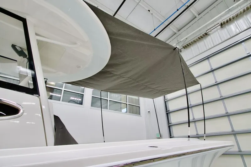 Slide: The Image of 2026 Regulator 31 boat with canopy in a modern indoor facility. - 13