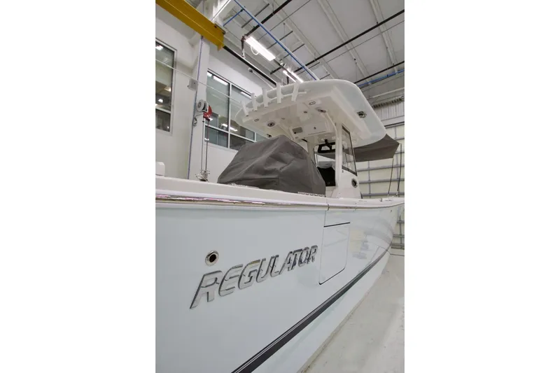 Slide: The Image of 2026 Regulator 31 boat in a showroom, showcasing sleek design and modern features. - 14