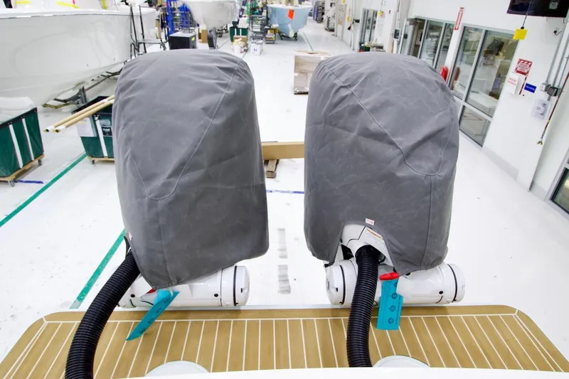 Slide: The Image of Covered engines on a 2026 Regulator 31 boat in a manufacturing facility. - 16