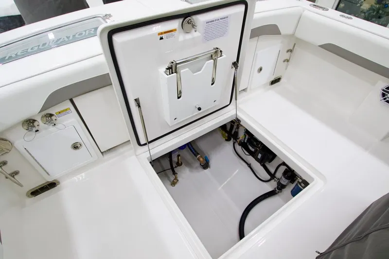 Slide: The Image of 2026 Regulator 31 boat interior showing storage compartment and equipment access. - 17