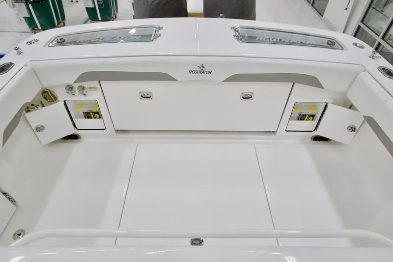 Slide: The Image of 2026 Regulator 31 boat interior with storage compartments and sleek white design. - 21