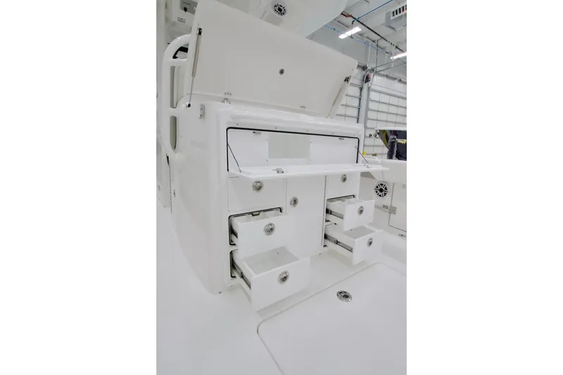 Slide: The Image of 2026 Regulator 31 boat storage compartments with open drawers in a bright interior. - 25