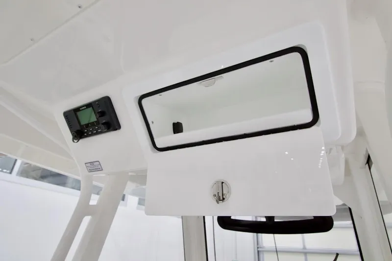 Slide: The Image of 2026 Regulator 31 boat console with open storage compartment and electronic display. - 33