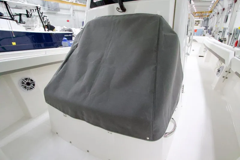 Slide: The Image of 2026 Regulator 31 boat console covered in a protective gray fabric. - 34