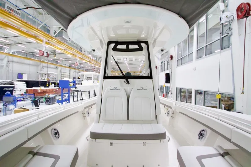 Slide: The Image of 2026 Regulator 31 boat interior in a manufacturing facility, showcasing seating and helm. - 36