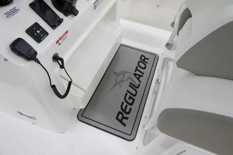 Slide: The Image of Interior of 2026 Regulator 31 boat with branded mat and control panel. - 43