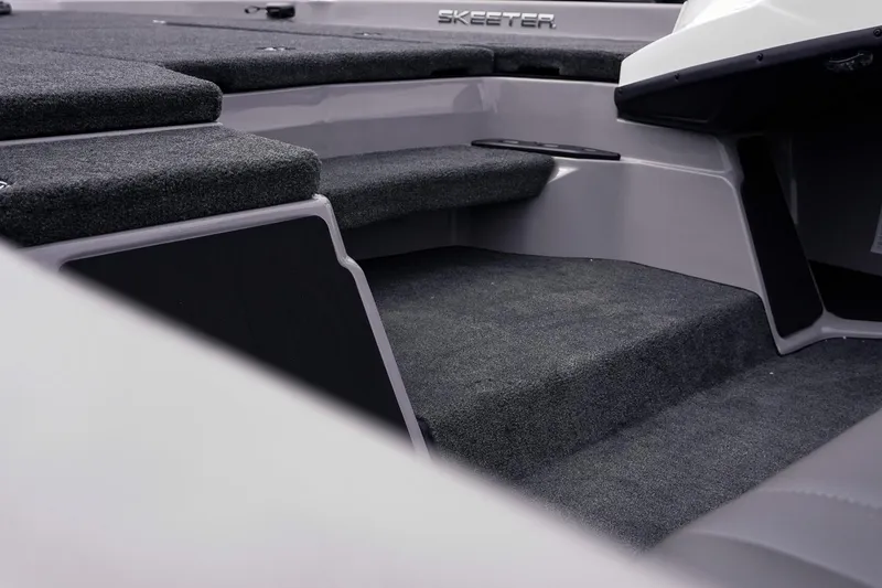 Slide: The Image of 2026 Skeeter ZXR20 SE boat interior with carpeted steps and seating area. - 11