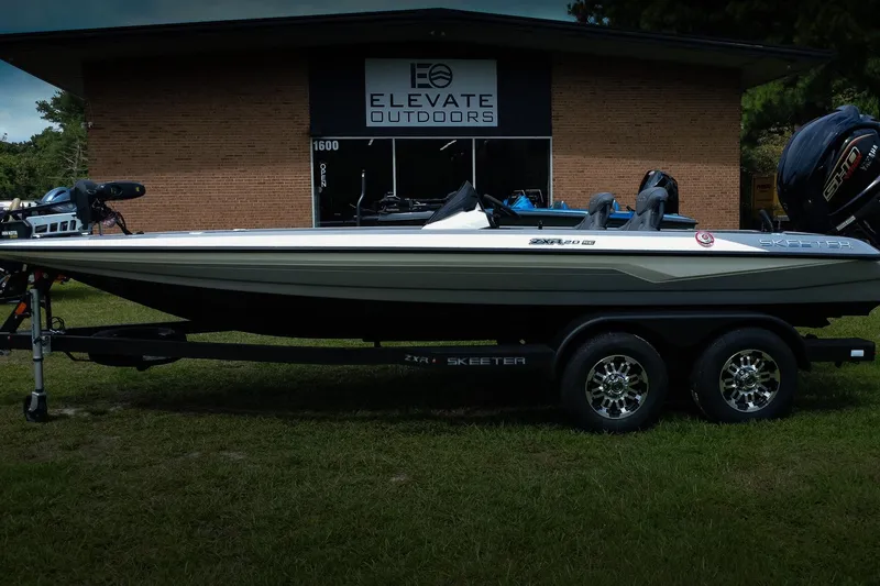 Slide: The Image of 2026 Skeeter ZXR20 SE boat on trailer outside Elevate Outdoors store. - 2