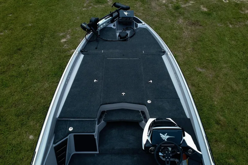 Slide: The Image of 2026 Skeeter ZXR20 SE boat deck with steering wheel, on grassy background. - 3