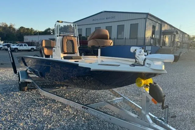 Slide: The Image of 2026 Xpress H20B Bay boat on trailer, parked outside a marine building. - 4