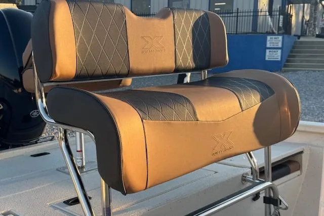 Slide: The Image of 2026 Xpress H20B Bay boat seat with diamond-stitched upholstery in sunlight. - 6