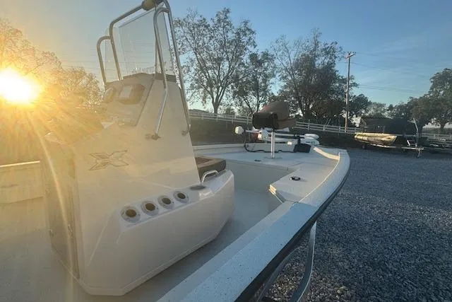 Slide: The Image of 2026 Xpress H20B Bay boat at sunrise, showcasing sleek design and modern features. - 8