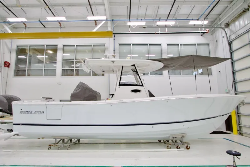 The Image of 2026 Regulator 31 boat in a modern indoor facility, side view. - 10