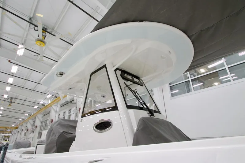 Slide: The Image of 2026 Regulator 31 boat in a modern indoor facility, showcasing sleek design and craftsmanship. - 12