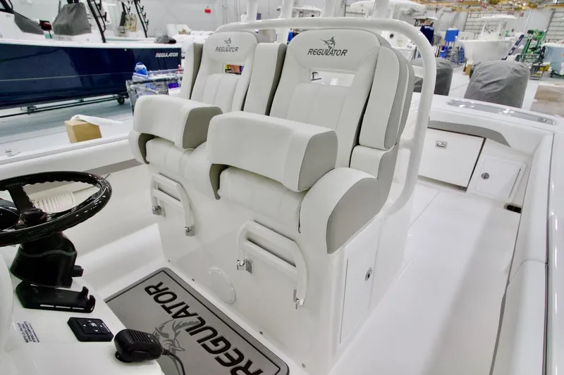 Slide: The Image of 2026 Regulator 31 boat interior with dual white captain's chairs and steering wheel. - 28