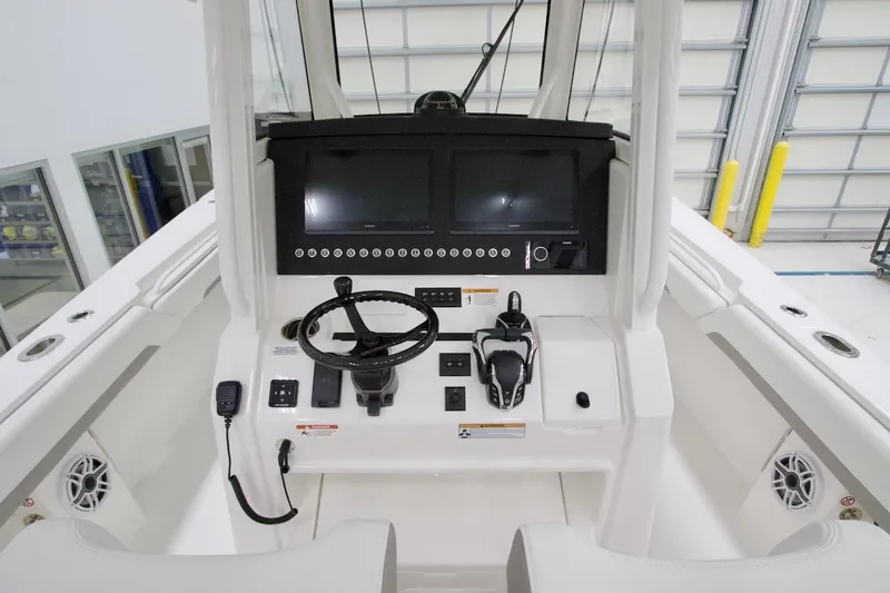 Slide: The Image of 2026 Regulator 31 boat helm with modern controls and dual screens. - 31